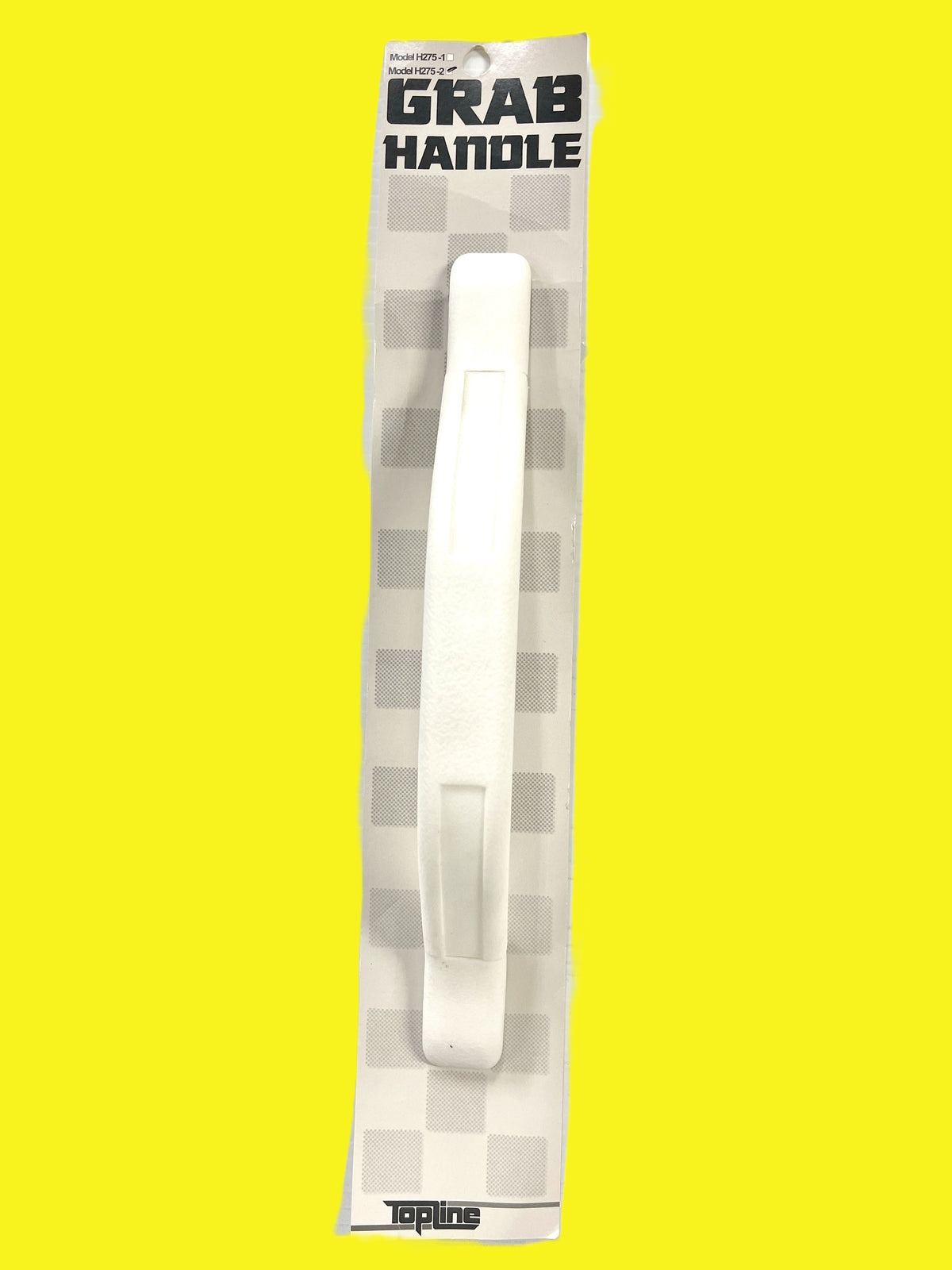 A white grab assist handle against a yellow background