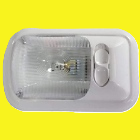 A white interior light with a clear lens and a switch