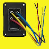 A black rectangular electrical outlet cover plate with four colored wires (yellow, blue, red, and white) extending from the back, shown on a plain yellow background.