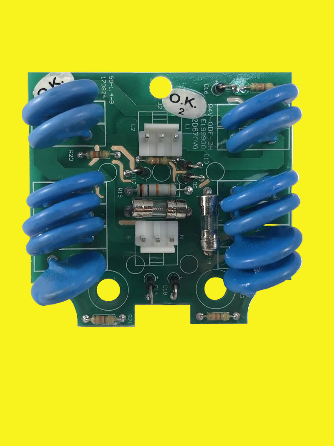 A green printed circuit board (PCB) surge protection module with blue   capacitors, and various other electronic components.